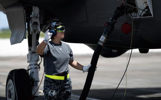 A Japanese airman refuels an F-35A Lightning II during a hot-pit refuel at Andersen Air Force Base, Guam, Aug. 28, 2023.