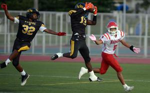 Dylan O'Neal pulls down one of three interceptions by Kadena against Kinnick.