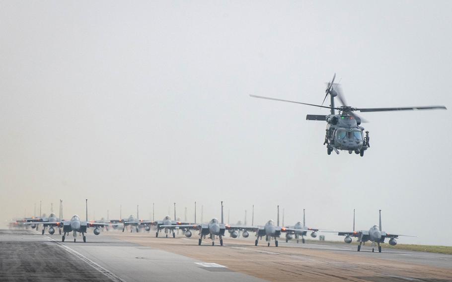 A formation of F-15 Eagles, a KC-135 Stratotanker, an E-3 Sentry and an HH-60 Pavehawk taxis down the runway at Kadena Air Base, Okinawa, Wednesday, March 2, 2022.