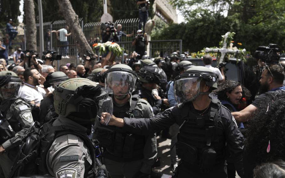 Israeli police in riot gear confront mourners and the journalists covering the transfer from the hospital of slain Al Jazeera veteran journalist Shireen Abu Akleh to her final resting place, in east Jerusalem, Friday, May 13, 2022.