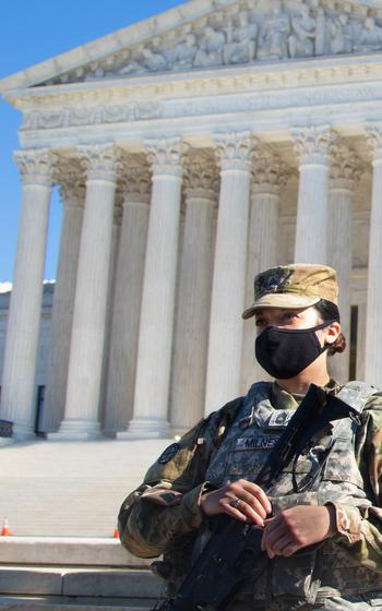 A soldier with the Kansas National Guard stands in front of the U.S. Supreme Court Feb. 5, 2021. A draft Supreme Court decision that would overturn Roe v. Wade was recently leaked, not long after the Army and Air Force issued guidance that would prevent commanders from denying leave to service members seeking an abortion.