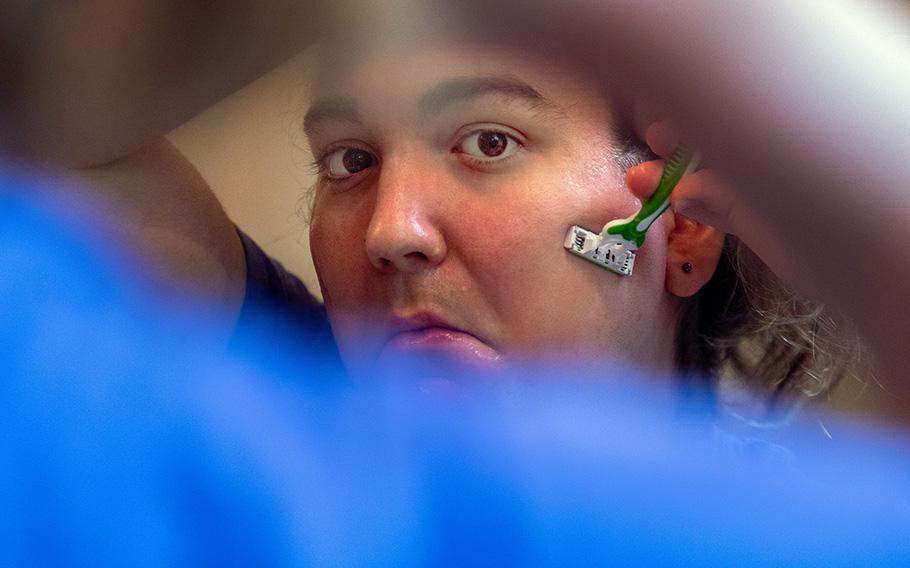 Violet Rin, 27, shaves her face in the morning before work. Since she came out last year as a transgender woman, lawmakers in her home state of Florida have restricted the rights of trans people, including her access to hormones.