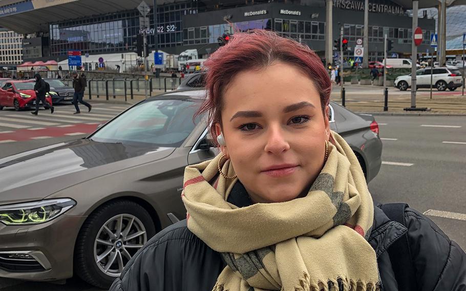 Justina Dziwicka, a child care worker, stands in front of the main train station in Warsaw that has become a hub for Ukrainian refugees. 