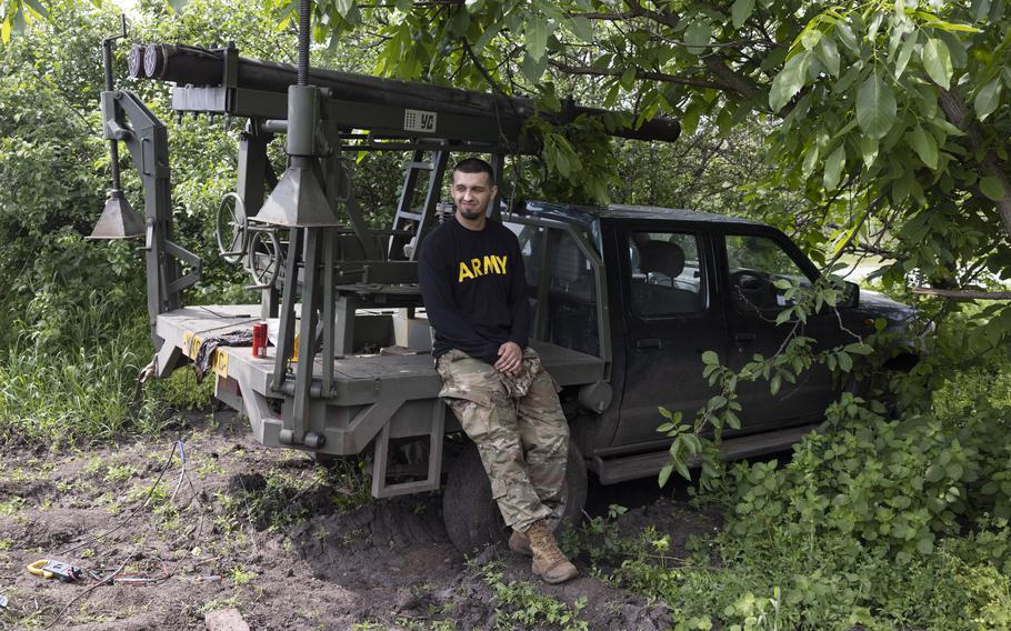 A Ukrainian commander known by his call sign, Chichen, sits by a modified missile launcher on a pickup truck outside the headquarters of the 24th Separate Assault Battalion in Kostyantynivka on May 26, 2023. 