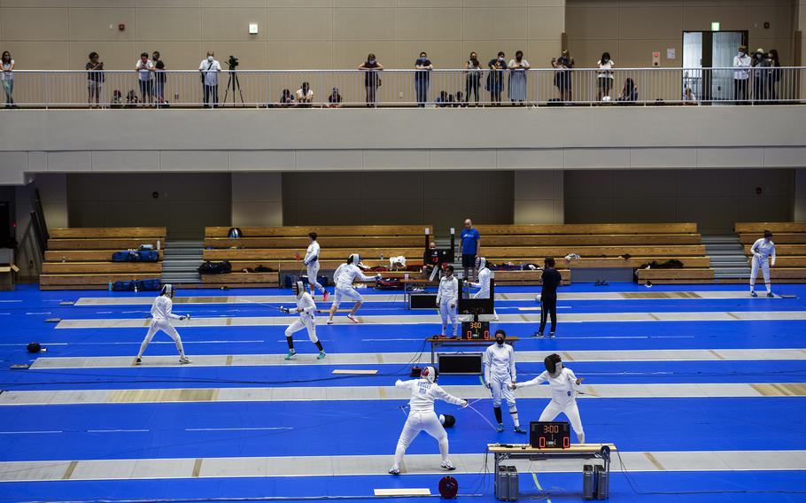 A handful of spectators watch as members of the U.S. women’s Olympic fencing team practice inside the Lotus Culture Center Arena, part of the Atago Sports Complex, in Iwakuni, Japan, July 14, 2021.