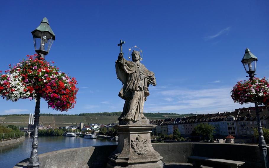 The statue of John of Nepomuk on the Alte Mainbrucke, the old stone bridge over the Main River in Wuerzburg, Germany.