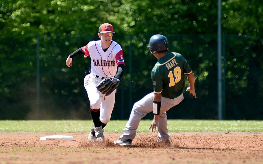 Kaiserslautern shortstop James Leonard goes to tag SHAPE baserunner Donovan Traylor near second base during the first inning of the second game of a doubleheader on May 11, 2024, at Pulaski Park in Kaiserslautern, Germany.