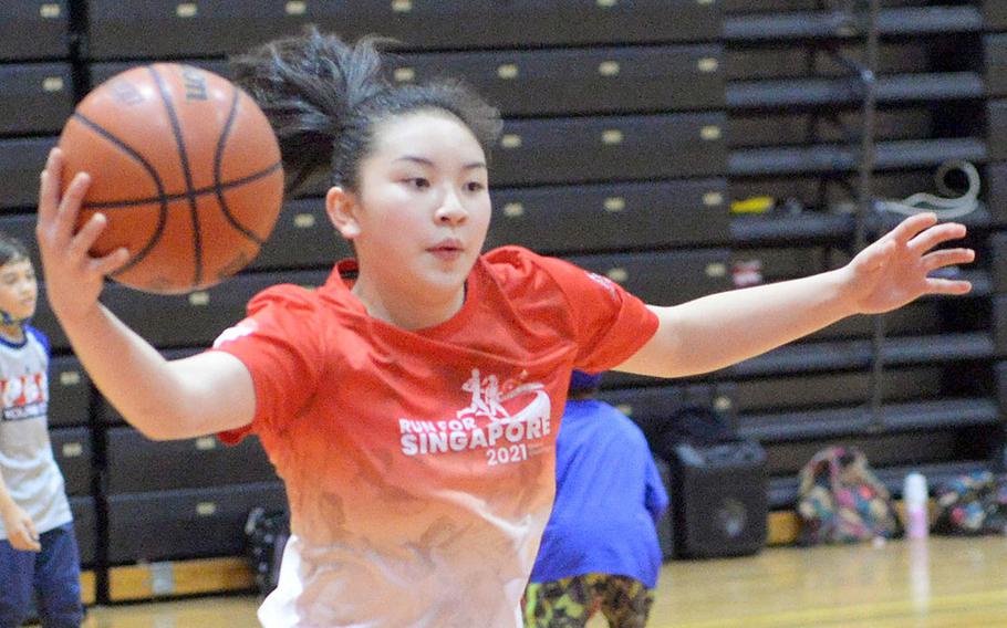 Freshman Jasmine Pho, a transfer from Singapore, is a second-generation Kinnick girls basketball player; her mother, Jessica Sugihara, played for the Red Devils in the early 1990s.