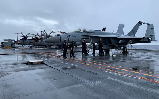 Crews work on aircraft aboard the flight deck of the USS Gerald R. Ford in the north Atlantic Ocean on Nov. 13, 2022. The Navy’s newest aircraft carrier is on its maiden deployment after leaving Norfolk, Va., last month.