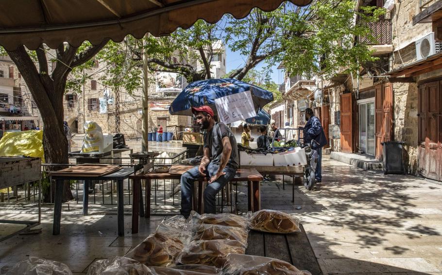 A vendor waits for customers at a souk in Sidon, Lebanon, on April 14, 2021. 