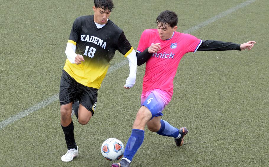 Kadena's Gabriel Cedeno and Nile C. Kinnick's Kevin Serrano scuffle for the ball in the wind and rain at Yokosuka.