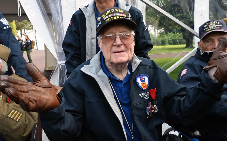 A man wears a hat that declaring him a World War II veteran.