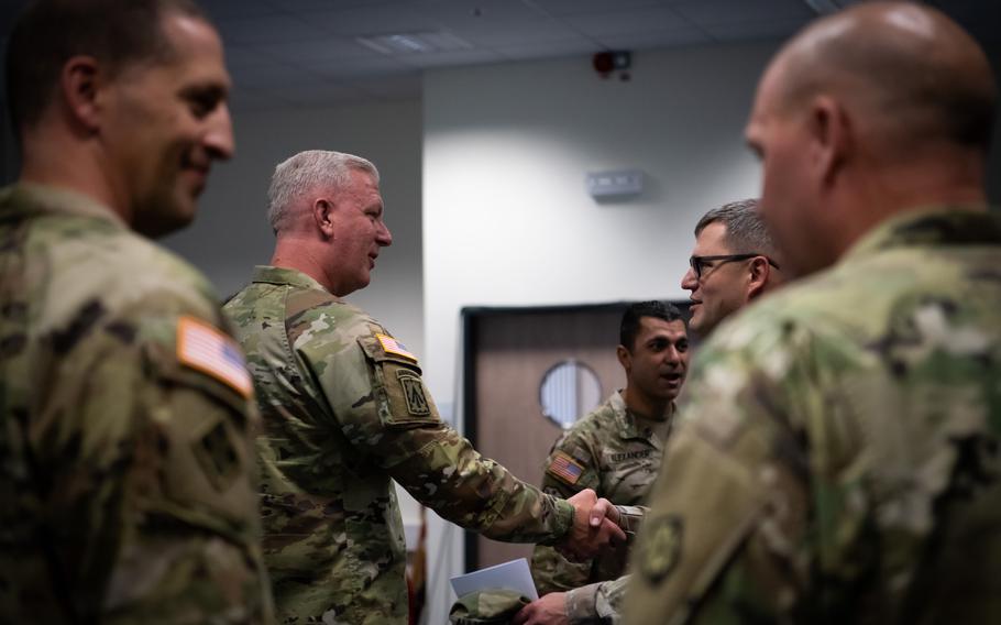 Army Col. Bruce A. Bredlow, center left, speaks with fellow soldiers at Sembach Kaserne after assuming command of the 52nd Air Defense Artillery Brigade on Oct. 6, 2022. 