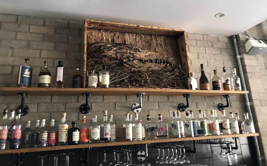 The Phat Mango restaurant in Darwin, Australia, has a simple, uncluttered interior decorated with aboriginal art and a large, carved wooden crocodile looming over the bar.