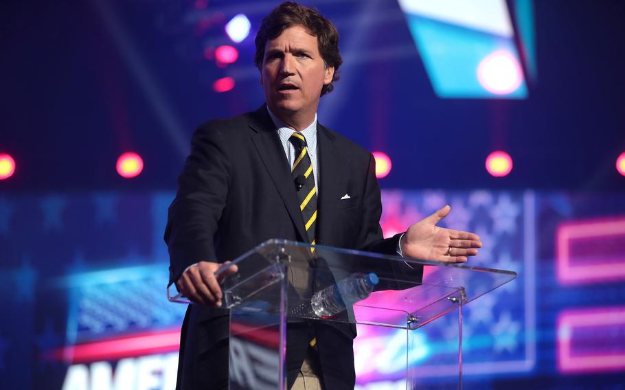 Tucker Carlson speaking with attendees at the 2021 AmericaFest at the Phoenix Convention Center in Phoenix, Ariz., on Dec. 18, 2021. 