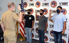JOINT BASE SAN ANTONIO, FORT SAM HOUSTON – (Oct. 1, 2020) Left to right: Jese David of San Antonio, Alexander Ortiz of Pflugerville, Texas, and Jacob Teran, of San Antonio, took the oath of enlistment into America’s Navy at Navy Talent Acquisition Group (NTAG) San Antonio headquarters becoming the first enlistees to take the oath under the newly established NTAG. David, a 2018 graduate of Robert E. Lee High School, will serve in the Master-at-Arms career field; Ortiz, a senior attending Weiss High School, will serve in the nuclear propulsion field; and Teran, a 2018 graduate of Brackenridge High School, will become an engineman.   The oath was administered by Lt. Michael Wojdyla, of Fence, Wis., officer-in-charge, Talent Acquisition On-Boarding Center Alamo City. NTAG San Antonio's (formerly Navy Recruiting District San Antonio) area of responsibility includes more than 34 Navy Recruiting Stations and Navy Officer Recruiting Stations spread throughout 144,000 square miles of Central and South Texas territory. (U.S. Navy Photo by Burrell Parmer, Navy Recruiting District San Antonio/Released)
