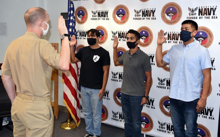 Jese David of San Antonio, Alexander Ortiz of Pflugerville, Texas, and Jacob Teran of San Antonio took the oath of enlistment into the Navy on Oct. 1, 2020, at Joint Base San Antonio. The Army, Navy, Air Force and Marine Corps shipped fewer recruits to boot camps in fiscal year 2020 than a year earlier, as the services shut down their recruiting facilities and moved their efforts to attract new troops entirely online for months, according to a study by the Rand Corp. published Tuesday. 