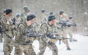 U.S. soldiers assigned to NATO's battlegroup in Poland bellow a war cry during a bayonet training exercise March 10, 2023. NATOs annual report released March 21 noted that the U.S. accounts for 54% of the allies combined GDP but 70% of NATO defense expenditure.