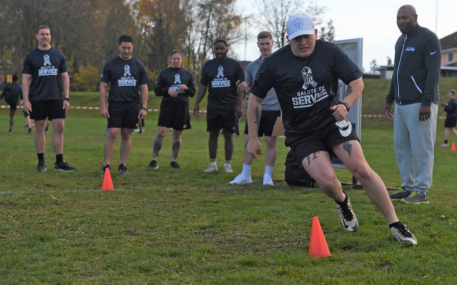 Staff Sgt. Nathen Gimlin does the three-cone drill at the NFL Salute to Service boot camp in Vilseck, Germany, on Nov. 9, 2022. 