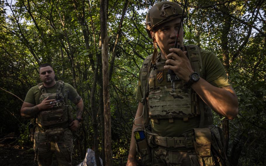 Gerych talks on a radio at the base of a mortar unit near Klishchiivka on July 4, 2023. 