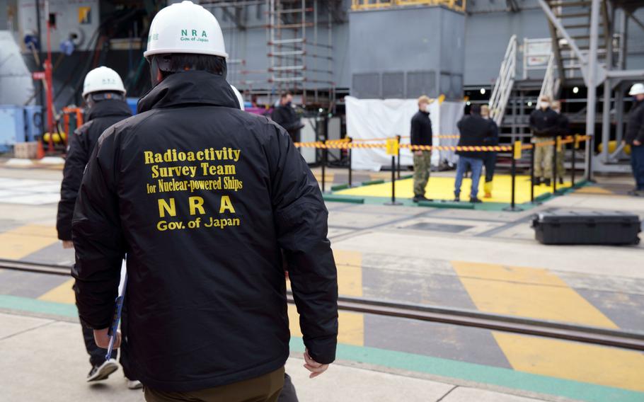 A Japanese radioactive survey team approaches the aircraft carrier USS Ronald Reagan during a radiation-leak drill at Yokosuka Naval Base, Japan, Feb. 2, 2023.