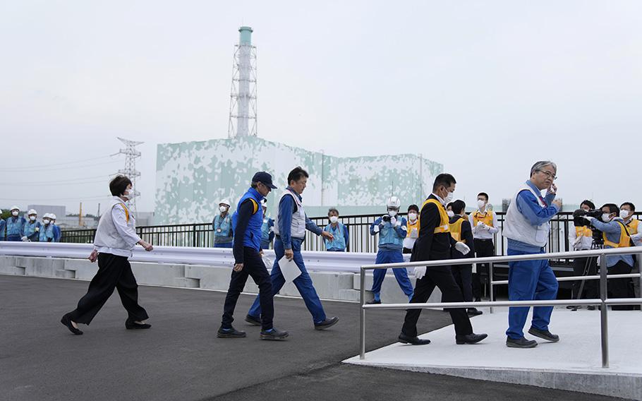 Rafael Mariano Grossi, Director General of the International Atomic Energy Agency, second left, arrives to inspect the damaged Fukushima nuclear power plant in Futaba, northeastern Japan, on July 5, 2023.