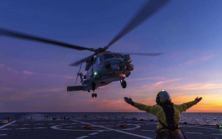 An Australian Seahawk helicopter lands on the deck of HMAS Hobart during flying operations off northern Australia.