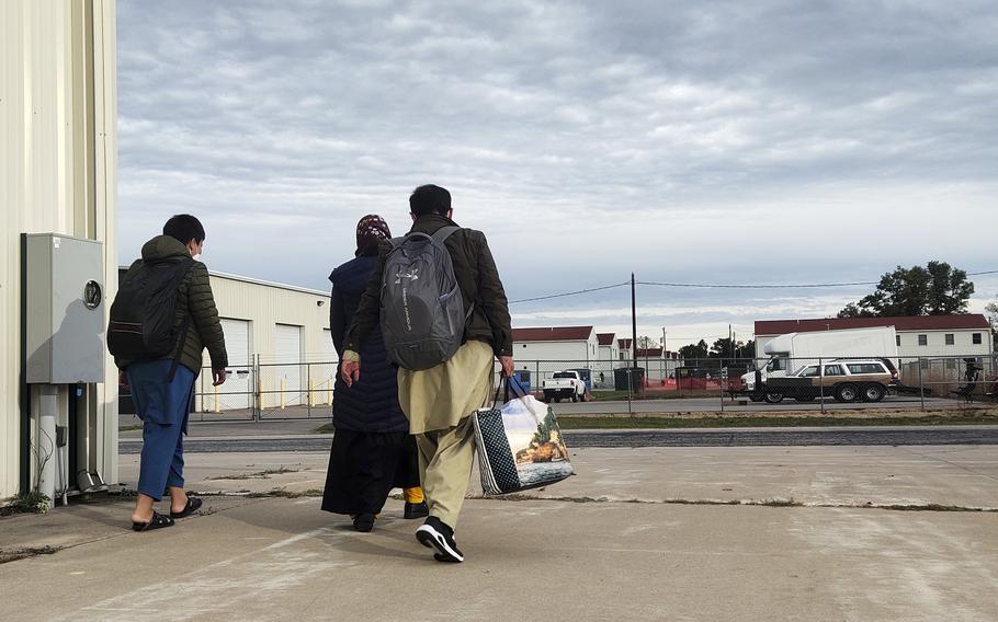 An Afghan family prepares to leave Fort McCoy, Wis., Oct. 11, 2021. The 30 evacuees who left on a bus that day were among the first 1,200 to take the next step of resettlement in America.