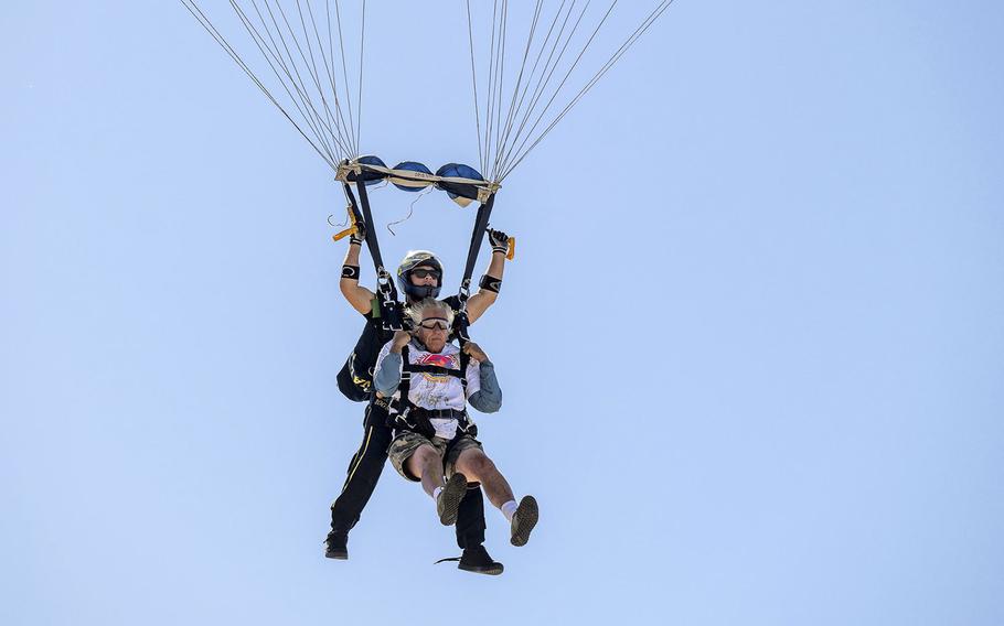 Navy Leap Frog member Nick Ray and surfer Don Ramsey float to earth after jumping out of a Navy Leap Frogs airplane as part of the lead up for this year’s Pacific Airshow in Huntington Beach, Calif. The airshow runs from Sept. 29 to Oct. 2. 