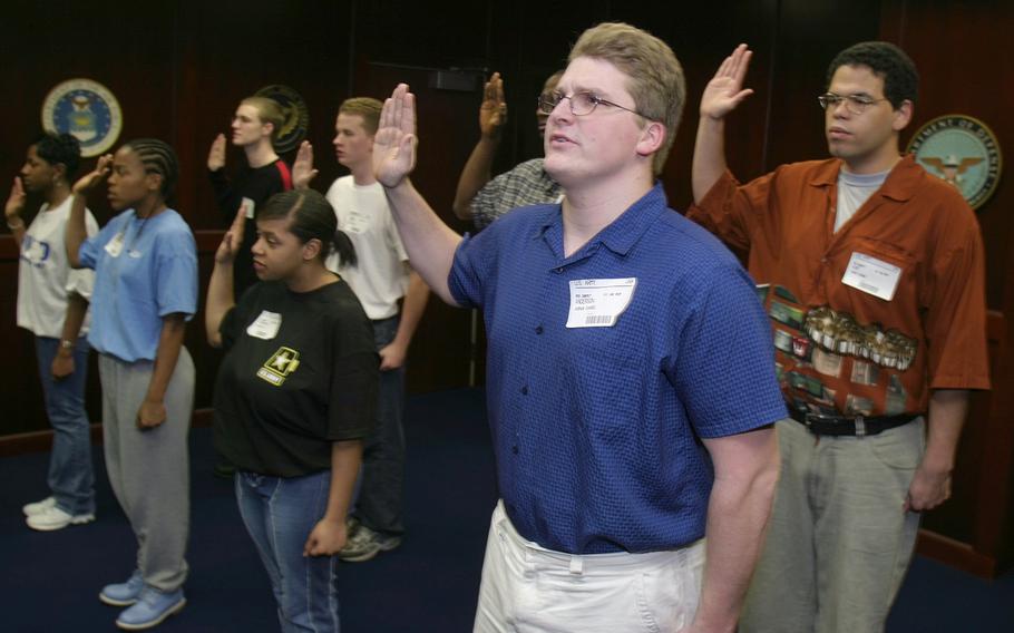 Army inductees, including Josh Anderson, center, take the oath of enlistment at the Federal Building in Richmond, Va., Thursday, April 3, 2003. Anderson said at the time that his resolve to join the Army during wartime was “stronger than ever.”