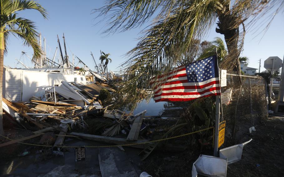 A flag flies at a mobile home park on San Carlos Island in the Fort Myers area days after Hurricane Ian hit Florida in late September 2022.