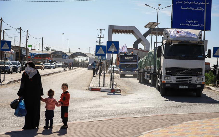 The first trucks carrying humanitarian aid cross from Egypt into the Gaza Strip in Rafah, Gaza, on Oct. 21.