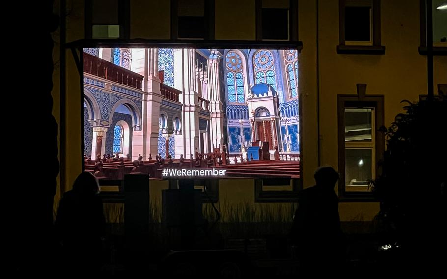 Visitors view a video rendering of the Kaiserslautern Synagogue in Kaiserslautern, Germany, Nov. 9, 2021. Created by the Technical University Darmstadt, the virtual reconstruction shows the interior and exterior appearance of the Jewish house of worship before the Nazis destroyed it in 1938.