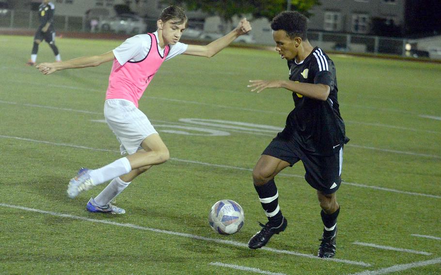 Kadena's Elijah Whipp moves the ball upfield against Kubasaki's Jaden Ducat during Wednesday's Okinawa boys soccer match. The Panthers won 6-0.