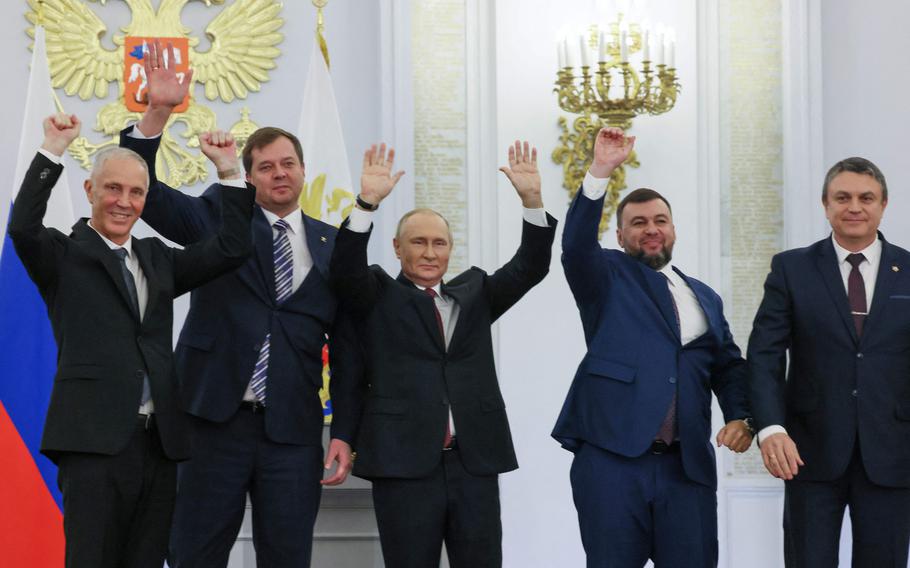 From left to right: The Moscow-appointed heads of Kherson region Vladimir Saldo and Zaporizhzhia region Yevgeny Balitsky, Russian President Vladimir Putin, Donetsk separatist leader Denis Pushilin and Luhansk separatist leader Leonid Pasechnik react after signing treaties formally annexing four regions of Ukraine Russian troops occupy, at the Kremlin in Moscow on Sept. 30, 2022.