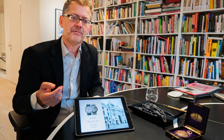 Robert Putenhofer of Carl Suchy & Soehne with historic pocket watch and images of the new Waltz No. 1 watch. 