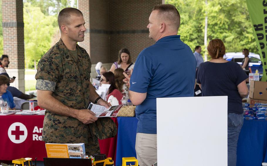 .S. Marine Corps Sgt. Maj. Dustin Nelson, sergeant major, Wounded Warrior Battalion-East, meets with different booths raising awareness for post-traumatic stress disorder during the Lin Weidow Memorial, Camp Lejeune, N.C., May 24, 2018. Members of WWBn-E memorialized a cherished colleague, known for her outstanding dedication in helping recovering service members and having a positive impact on her peers. 