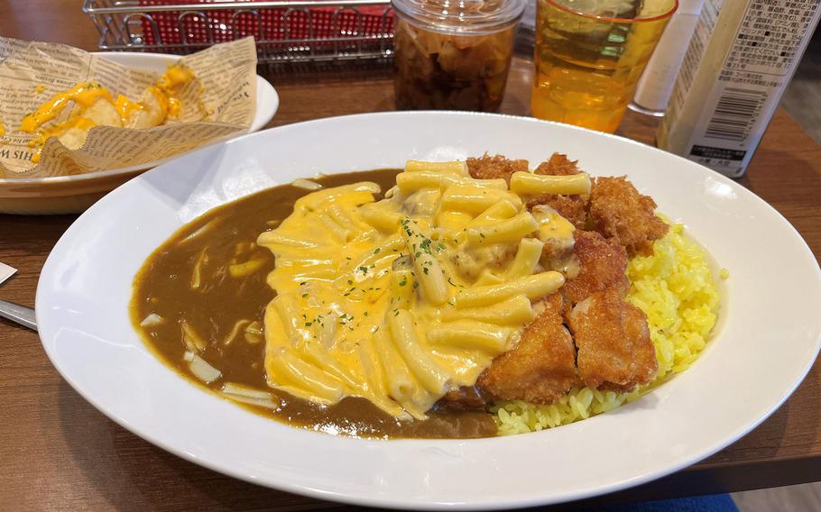 A white bowl contains brown and yellow soupy and chunky food.