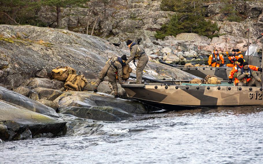 U.S. Marines from 2nd Reconnaissance Battalion, 2nd Marine Division, unload gear from a Finnish landing craft during Freezing Winds 23 off the coast of Finland, Nov. 2, 2023.