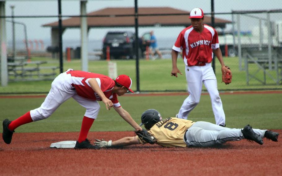 Kinnick's Noah Berhow tries to tag Humphreys' Skyler Allison during Tueday's Division I baseball playoff game. The Red Devils won 7-2.