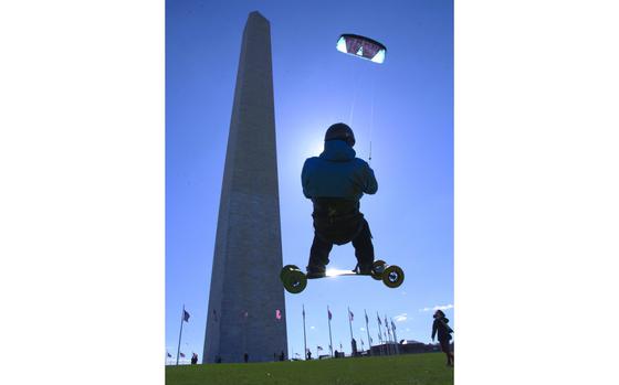 Washington, D.C., Mar. 28, 2015: Landboarder Lon Phan of Silver Spring, Md., is silhouetted against the sun as takes to the air in front of the Washington Monument in the early minutes of the National Kite Festival, in Washington, D.C. The annual event is part of the National Cherry Blossom Festival. 

Wondering when the cherries and tulips will bloom in your area? Check out Stars and Stripes communities websites.
https://ww2.stripes.com/communities

META TAGS: Spring; Kite Festival; Cherry blossoms; tulips; keukenhof; Spring festivals