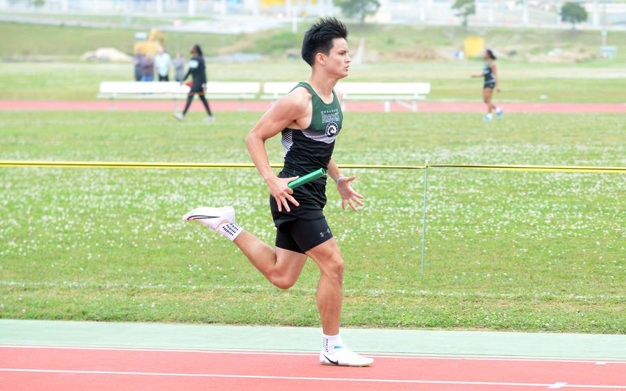 Ryan Hater runs in a relay event.