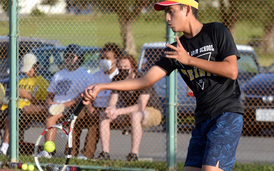 Kadena's Justin Saavedra hits a forehand return against teammate Evan Davis.