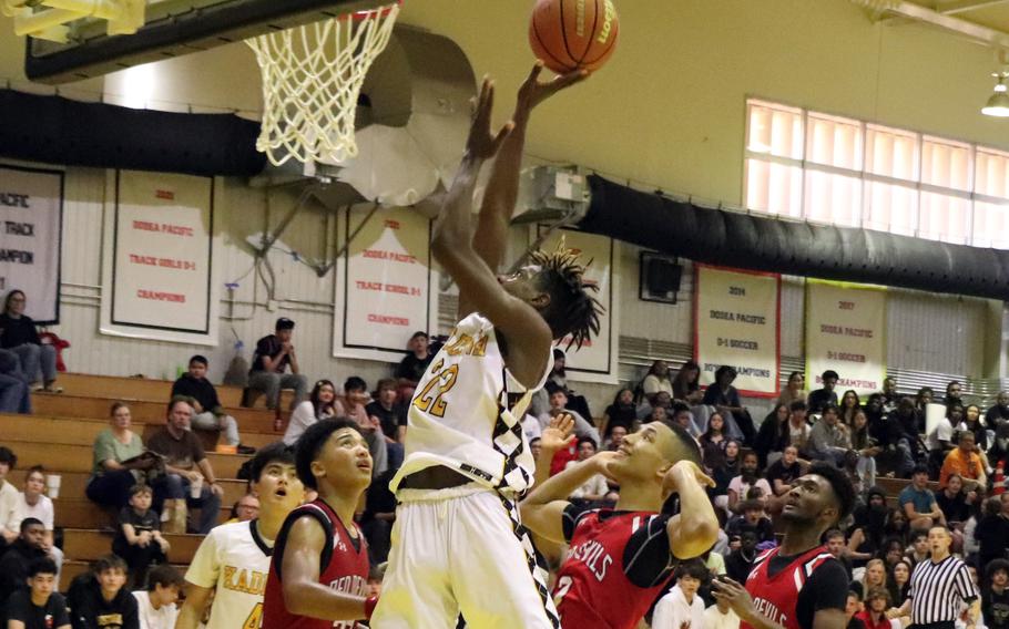 Kadena's Jayden Allen goes up to shoot over Kinnick's Vance Lewis.