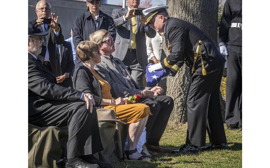 A flag is presented to Gary Bishop and his wife, Carla, during an interment service Thursday at Arlington National Cemetery for Herman Schmidt, Bishop’s granduncle.