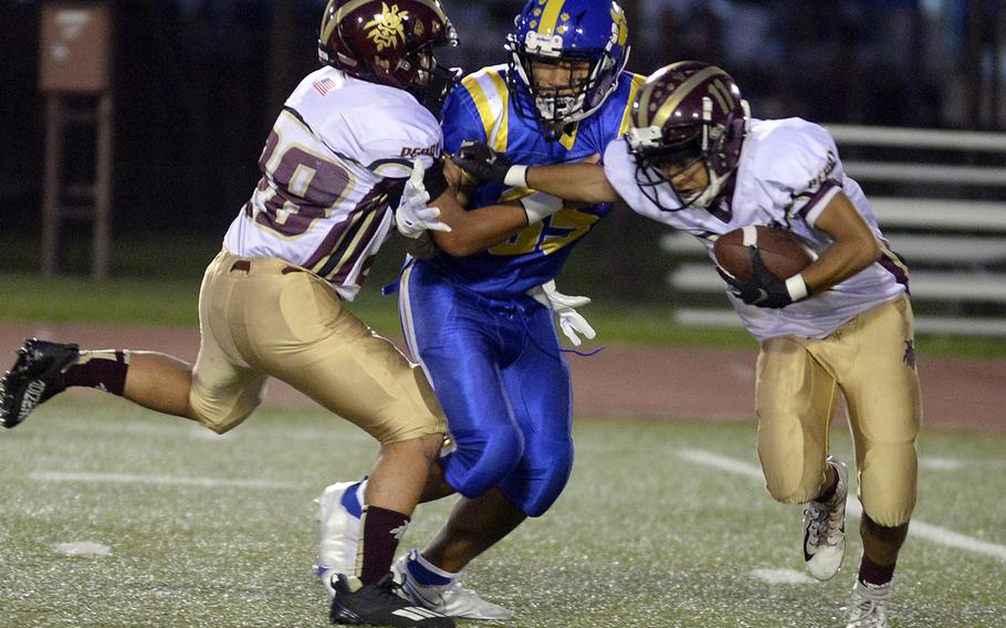 Matthew C. Perry’s Eddie Pacleb gets some help from teammate Ronald Reyes in dealing with Yokota’s Noah Cruz.