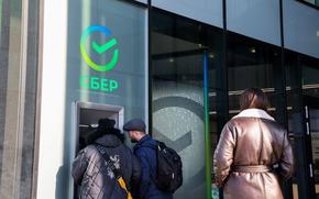 Customers use an ATM outside a Sberbank branch in Moscow on Feb. 28, 2022. 