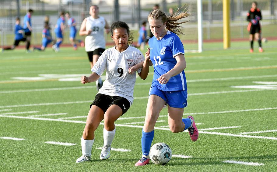 Ramstein left winger Kayla Groat holds off Kaiserslautern's Mikayla Dela Crus during a match on April 12, 2024, at Ramstein High School on Ramstein Air Base, Germany.