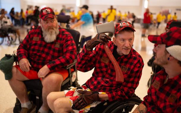 Todd Kemery, a former Marine from Shakopee, clowns around with a plastic axe belonging to Tim Valentin, left, an Army veteran from Belle Plaine, before opening ceremonies Thursday for the 44th annual National Veterans Wheelchair Games. (Jeff Wheeler / The Minnesota Star Tribune)