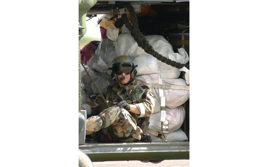 Master Sgt. Chaz Stiefken from the 33rd Rescue Squadron crams in to his HH-60G helicopter to deliver supplies to relief centers in the Philippines.